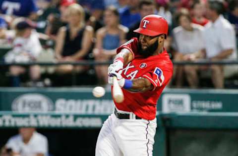 ARLINGTON, TX – JULY 4: Danny Santana #38 of the Texas Rangers makes contact for a RBI double during the fourth inning of a baseball game against the Los Angeles Angels of Anaheim at Globe Life Park in Arlington on July 4, 2019 in Arlington, Texas. (Photo by Brandon Wade/Getty Images)