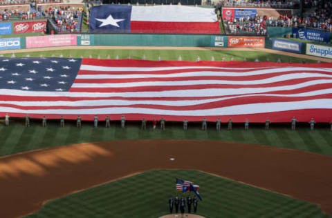 ARLINGTON, TX – JULY 04: Members of the United States military unfurl a large American Flag during the National Anthem before a baseball game between the Los Angeles Angels of Anaheim and the Texas Rangers at Globe Life Park July 4, 2019 in Arlington, Texas. (Photo by Brandon Wade/Getty Images)