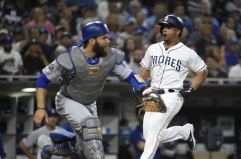 SAN DIEGO, CA – SEPTEMBER 25: Francisco Mejia #27 of the San Diego Padres scores ahead of the throw to Russell Martin #55 of the Los Angeles Dodgers during the the first inning of a baseball game at Petco Park September 25, 2019 in San Diego, California. (Photo by Denis Poroy/Getty Images)