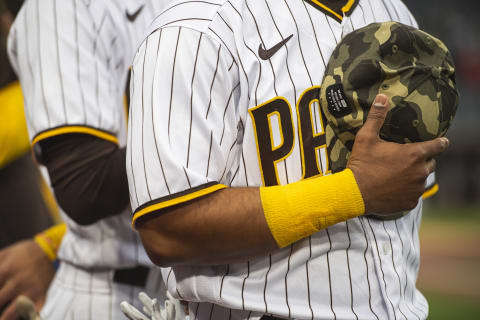 SAN DIEGO, CA – MAY 14: Ivan Castillo #61 of the San Diego Padres holds his hat against his chest during the National Anthem before the game against the St Louis Cardinals at Petco Park on May 14, 2021 in San Diego, California. Players are wearing camouflage hats in honor of Armed Forces Weekend. (Photo by Matt Thomas/San Diego Padres/Getty Images)