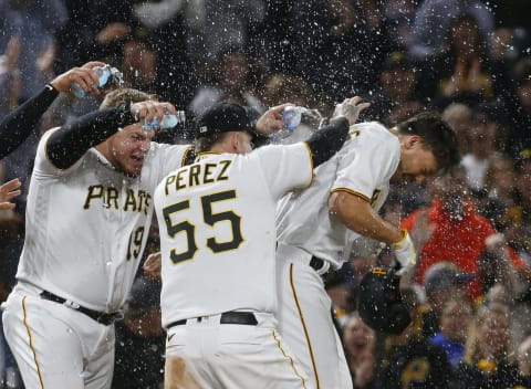 PITTSBURGH, PA – APRIL 30: Bryan Reynolds #10 of the Pittsburgh Pirates celebrates with teammates after driving in the winning run in the tenth inning against the San Diego Padres during the game at PNC Park on April 30, 2022 in Pittsburgh, Pennsylvania. (Photo by Justin K. Aller/Getty Images)