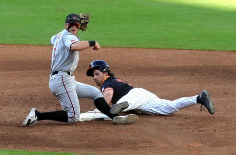 HOUSTON, TEXAS – MARCH 06: Jace Jung #2 of the Texas Tech Red Raiders tags out Blake Faecher #3 of the Sam Houston State Bearkats in the fourth inning at Minute Maid Park on March 06, 2021 in Houston, Texas. (Photo by Bob Levey/Getty Images)