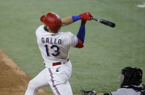 ARLINGTON, TX - JULY 27: Joey Gallo #13 of the Texas Rangers hits a three-run home run against the Arizona Diamondbacks during the fourth inning at Globe Life Field on July 27, 2021 in Arlington, Texas. (Photo by Ron Jenkins/Getty Images)