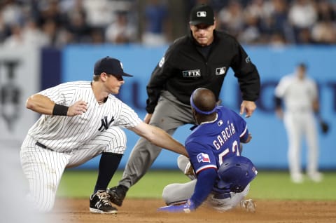 NEW YORK, NEW YORK – SEPTEMBER 22: Adolis Garcia #53 of the Texas Rangers is caught stealing second base by DJ LeMahieu #26 of the New York Yankees during the eighth inning at Yankee Stadium on September 22, 2021 in New York City. The Yankees defeated the Rangers 7-3. (Photo by Jim McIsaac/Getty Images)