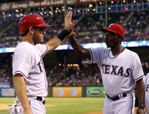 ARLINGTON, TX – AUGUST 1: Ian Kinsler #5 is congratulated by manager Ron Washington #38 of the Texas Rangers after scoring against the Arizona Diamondbacks in the interleague game at Rangers Ballpark in Arlington on August 1, 2013 in Arlington, Texas. (Photo by Rick Yeatts/Getty Images)