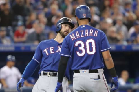 TORONTO, ON – APRIL 27: Joey Gallo #13 of the Texas Rangers celebrates with Nomar Mazara #30 after both runners scored on a two-run single by Ronald Guzman #67 in the sixth inning during MLB game action against the Toronto Blue Jays at Rogers Centre on April 27, 2018 in Toronto, Canada. (Photo by Tom Szczerbowski/Getty Images)