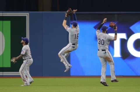 TORONTO, ON – APRIL 28: Delino DeShields #3 of the Texas Rangers and Joey Gallo #13 and Nomar Mazara #30 celebrate their victory in the outfield during MLB game action against the Toronto Blue Jays at Rogers Centre on April 28, 2018 in Toronto, Canada. (Photo by Tom Szczerbowski/Getty Images)