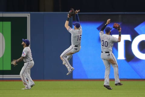 TORONTO, ON – APRIL 28: Delino DeShields #3 of the Texas Rangers and Joey Gallo #13 and Nomar Mazara #30 celebrate their victory in the outfield during MLB game action against the Toronto Blue Jays at Rogers Centre on April 28, 2018 in Toronto, Canada. (Photo by Tom Szczerbowski/Getty Images)