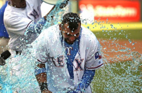 ARLINGTON, TX – JUNE 17: Jose Trevino #71 of the Texas Rangers is doused by teammates after he hit a game winning two-run single against the Colorado Rockies in the bottom of the ninth inning at Globe Life Park in Arlington on June 17, 2018 in Arlington, Texas. The Rangers won 13-12. (Photo by Ron Jenkins/Getty Images)