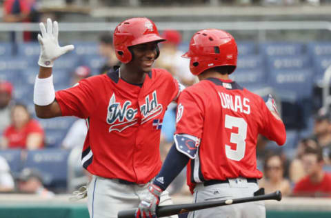 WASHINGTON, DC – JULY 15: Seuly Matias #25 of the Kansas City Royals and the World Team celebrates with teammate Leody Taveras #3 of the Texas Rangers and the World Team after after hitting a solo home run against the U.S. Team in the second inning during the SiriusXM All-Star Futures Game at Nationals Park on July 15, 2018 in Washington, DC. (Photo by Rob Carr/Getty Images)