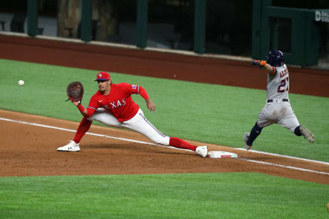 ARLINGTON, TEXAS – SEPTEMBER 25: Ronald Guzman #11 of the Texas Rangers stretches to get the out on Jose Altuve #27 of the Houston Astros in the third inning at Globe Life Field on September 25, 2020 in Arlington, Texas. (Photo by Richard Rodriguez/Getty Images)