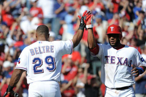 ARLINGTON, TX – OCTOBER 10: Elvis Andrus #1 of the Texas Rangers celebrates scoring with Adrian Beltre #29 in the first inning of Game Two of the American League Championship Series at Rangers Ballpark in Arlington on October 10, 2011 in Arlington, Texas. (Photo by Harry How/Getty Images)