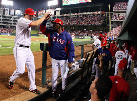 ARLINGTON, TX – OCTOBER 23: Derek Holland #45 of the Texas Rangers is congratulated by manager Ron Washington after the eighth inning during Game Four of the MLB World Series against the St. Louis Cardinals at Rangers Ballpark in Arlington on October 23, 2011 in Arlington, Texas. (Photo by Tom Pennington/Getty Images)