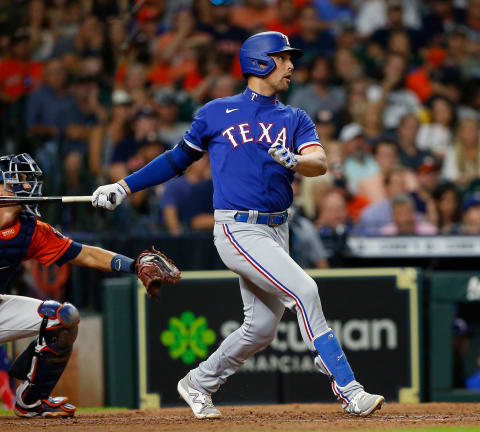 HOUSTON, TEXAS – JULY 23: Nate Lowe #30 of the Texas Rangers triples in two runs in the fifth inning against the Houston Astros at Minute Maid Park on July 23, 2021 in Houston, Texas. (Photo by Bob Levey/Getty Images)