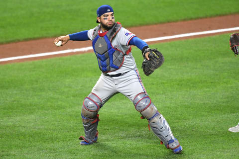 BALTIMORE, MD – SEPTEMBER 25: Jose Trevino #23 of the Texas Rangers fields a bunt during a baseball game against the Baltimore Orioles at Oriole Park at Camden Yards on September 25, 2021 in Baltimore, Maryland. (Photo by Mitchell Layton/Getty Images)