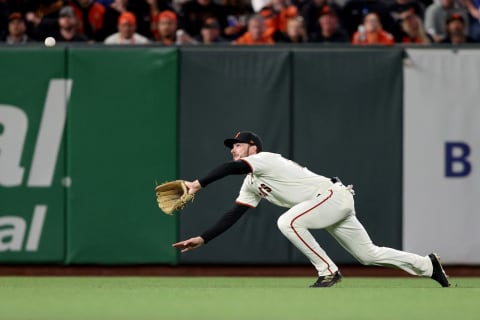 SAN FRANCISCO, CALIFORNIA – OCTOBER 09: Kris Bryant #23 of the San Francisco Giants dives to catch a fly ball in the seventh inning against the Los Angeles Dodgers during Game 2 of the National League Division Series at Oracle Park on October 09, 2021 in San Francisco, California. (Photo by Ezra Shaw/Getty Images)