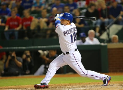 ARLINGTON, TX – APRIL 9: A.J. Pierzynski #12 of the Texas Rangers hits against the Tampa Bay Rays at Rangers Ballpark in Arlington on April 9, 2013 in Arlington, Texas. (Photo by Rick Yeatts/Getty Images)