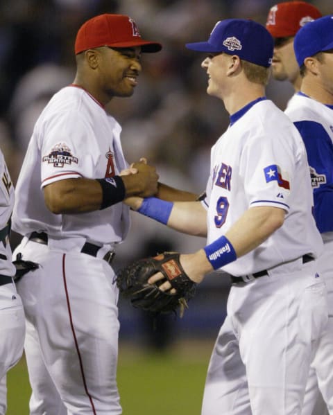 All-Star game MVP Garret Anderson (L) of the Anaheim Angels shakes hands with Hank Blalock (R) of the Texas Rangers who hit the game winning home run in the eighth inning 15 July, 2003 in the 74th mid-summer classic at US Cellular Field, in Chicago, IL. The American League beat the National League 7-6. AFP PHOTO/Jeff HAYNES (Photo credit should read JEFF HAYNES/AFP via Getty Images)