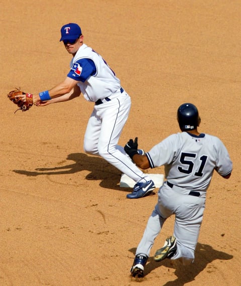 ARLINGTON, TX – MAY 22: Shortstop Michael Young #10 of the Texas Rangers forces out Bernie Williams #51 of the New York Yankees and completes the double play during the seventh inning at Ameriquest Field in Arlington on May 22, 2004 in Arlington, Texas. (Photo by Ronald Martinez/Getty Images)