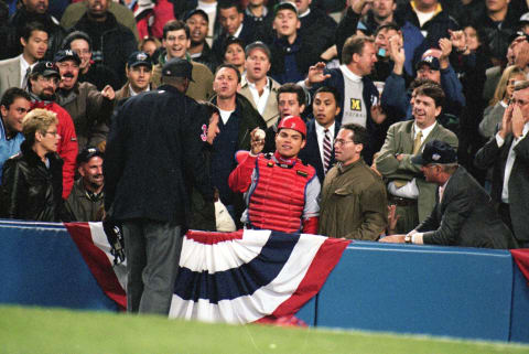 7 Oct 1999: Catcher Ivan Rodriguez #7 of the Texas Rangers shows the umpire the ball as he stands with the fans during the game against the New York Yankees at Yankee Stadium in Bronx, New York. The Yankees defeated the Rangers 3-1.