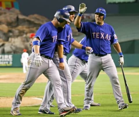 ANAHEIM, CA – SEPTEMBER 02: Hank Blalock #9 of the Texas Rangers is congratulated by his teammate Frank Catalanotto #27 and Michael Young #10 after hitting a grand slam homerun in the 8th inning against the Los Angeles Angels of Anaheim at Angels Stadium on September 2, 2007 in Anaheim, California. (Photo by Lisa Blumenfeld/Getty Images)