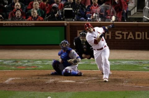 ST LOUIS, MO – OCTOBER 28: Yadier Molina #4 of the St. Louis Cardinals hits an RBI single to score Lance Berkman #12 in the seventh inning during Game Seven of the MLB World Series against the Texas Rangers at Busch Stadium on October 28, 2011 in St Louis, Missouri. (Photo by Rob Carr/Getty Images)