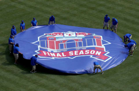 ARLINGTON, TEXAS – MARCH 28: Grounds crew members remove a tarp off the pitchers mound prior to the Texas Rangers taking on the Chicago Cubs during Opening Day at Globe Life Park in Arlington on March 28, 2019 in Arlington, Texas. (Photo by Tom Pennington/Getty Images)