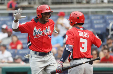 WASHINGTON, DC – JULY 15: Seuly Matias #25 of the Kansas City Royals and the World Team celebrates with teammate Leody Taveras #3 of the Texas Rangers and the World Team after after hitting a solo home run against the U.S. Team in the second inning during the SiriusXM All-Star Futures Game at Nationals Park on July 15, 2018 in Washington, DC. (Photo by Rob Carr/Getty Images)