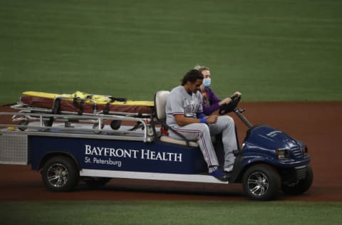 Apr 12, 2021; St. Petersburg, Florida, USA; Texas Rangers left fielder Ronald Guzman (11) leaves the game after suffering an apparent injury during the first inning against the Tampa Bay Rays at Tropicana Field. Mandatory Credit: Kim Klement-USA TODAY Sports