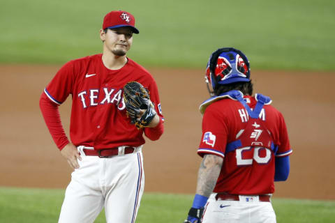 Apr 30, 2021; Arlington, Texas, USA; Texas Rangers starting pitcher Kohei Arihara (35) reacts as catcher Jonah Heim (28) walks to the mound in the first inning against the Boston Red Sox at Globe Life Field. Mandatory Credit: Tim Heitman-USA TODAY Sports