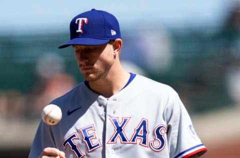 May 11, 2021; San Francisco, California, USA; Texas Rangers pitcher Brett de Geus (56) flips the ball to himself after hitting San Francisco Giants right fielder Mike Yastrzemski with a pitch during the seventh inning at Oracle Park. Mandatory Credit: D. Ross Cameron-USA TODAY Sports