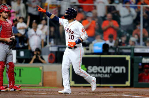 May 12, 2021; Houston, Texas, USA; Houston Astros first baseman Yuli Gurriel (10) gestures as he crosses home plate after hitting a two-run home run against the Los Angeles Angels during the first inning at Minute Maid Park. Mandatory Credit: Erik Williams-USA TODAY Sports