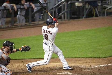 May 24, 2021; Minneapolis, Minnesota, USA; Minnesota Twins catcher Mitch Garver (8) hits a two run double in the eighth inning against the Baltimore Orioles at Target Field. Mandatory Credit: Jesse Johnson-USA TODAY Sports