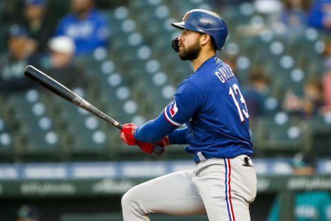 May 28, 2021; Seattle, Washington, USA; Texas Rangers right fielder Joey Gallo (13) hits a double against the Seattle Mariners during the fourth inning at T-Mobile Park. Mandatory Credit: Joe Nicholson-USA TODAY Sports