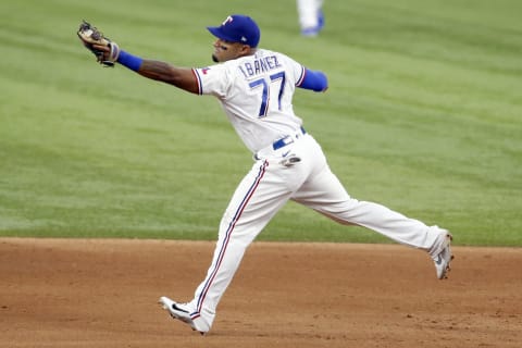 Aug 5, 2021; Arlington, Texas, USA; Texas Rangers second baseman Andy Ibanez (77) catches a ball in the sixth inning against the Los Angeles Angels at Globe Life Field. Mandatory Credit: Tim Heitman-USA TODAY Sports