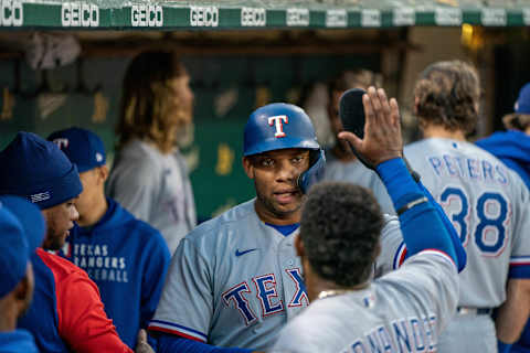 Aug 6, 2021; Oakland, California, USA; Texas Rangers first baseman Curtis Terry (83) is congratulated by teammates after scoring during the fifth inning against the Oakland Athletics at RingCentral Coliseum. Mandatory Credit: Neville E. Guard-USA TODAY Sports