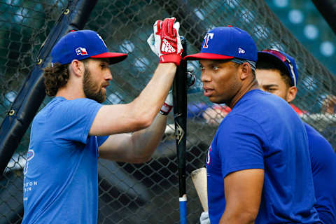 Aug 11, 2021; Seattle, Washington, USA; Texas Rangers left fielder Charlie Culberson (left) taps on a bat for designated hitter Curtis Terry (83) during batting practice before a game against the Seattle Mariners at T-Mobile Park. Mandatory Credit: Joe Nicholson-USA TODAY Sports