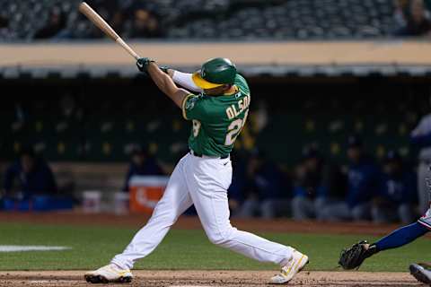 Sep 10, 2021; Oakland, California, USA; Oakland Athletics first baseman Matt Olson (28) hits a three-run RBI single during the second inning against the Texas Rangers at RingCentral Coliseum. Mandatory Credit: Stan Szeto-USA TODAY Sports