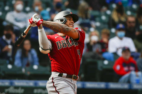 Sep 12, 2021; Seattle, Washington, USA; Arizona Diamondbacks center fielder Ketel Marte (4) hits a solo-home run against the Seattle Mariners during the seventh inning at T-Mobile Park. Mandatory Credit: Joe Nicholson-USA TODAY Sports