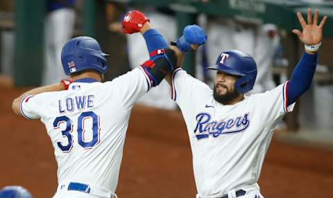 Sep 14, 2021; Arlington, Texas, USA; Texas Rangers first baseman Nathaniel Lowe (30) is congratulated by Texas Rangers shortstop Isiah Kiner-Falefa (9) after his two run home run in the first inning at Globe Life Field. Mandatory Credit: Tim Heitman-USA TODAY Sports