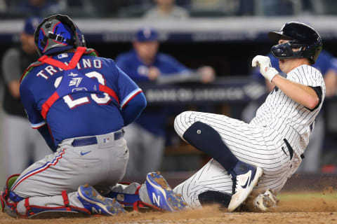 Sep 22, 2021; Bronx, New York, USA; New York Yankees catcher Kyle Higashioka (66) is tagged out by Texas Rangers catcher Jose Trevino (23) while trying to advance on a fly out by New York third baseman DJ LeMahieu (not pictured) during the fifth inning at Yankee Stadium. Mandatory Credit: Brad Penner-USA TODAY Sports