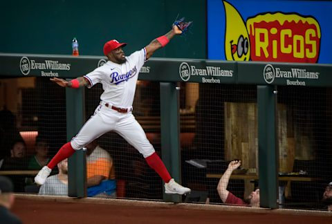 Sep 28, 2021; Arlington, Texas, USA; Texas Rangers right fielder Adolis Garcia (53) catches a foul ball hit by Los Angeles Angels second baseman David Fletcher (not pictured) during the second inning at Globe Life Field. Mandatory Credit: Jerome Miron-USA TODAY Sports