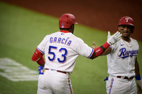 Sep 30, 2021; Arlington, Texas, USA; Texas Rangers right fielder Adolis Garcia (53) and designated hitter Andy Ibanez (77) celebrate Garcia hitting a home run against the Los Angeles Angels during the fifth inning at Globe Life Field. Mandatory Credit: Jerome Miron-USA TODAY Sports