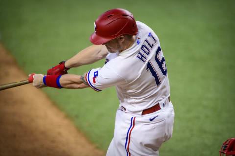 Sep 30, 2021; Arlington, Texas, USA; Texas Rangers third baseman Brock Holt (16) hits a double and drives in the winning runs against the Los Angeles Angels during the eighth inning at Globe Life Field. Mandatory Credit: Jerome Miron-USA TODAY Sports