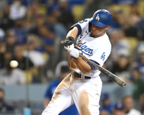 Sep 30, 2021; Los Angeles, California, USA; Los Angeles Dodgers shortstop Corey Seager (5) hits a solo home run in the seventh inning of the game against the San Diego Padres at Dodger Stadium. Mandatory Credit: Jayne Kamin-Oncea-USA TODAY Sports