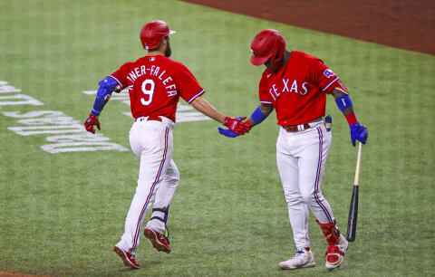 Oct 1, 2021; Arlington, Texas, USA; Texas Rangers shortstop Isiah Kiner-Falefa (9) celebrates with right fielder Adolis Garcia (53) after hitting a home run during the third inning against the Cleveland Indians at Globe Life Field. Mandatory Credit: Kevin Jairaj-USA TODAY Sports