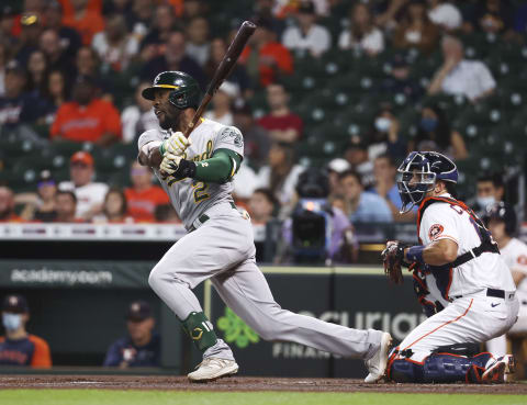 Oct 2, 2021; Houston, Texas, USA; Oakland Athletics center fielder Starling Marte (2) hits an RBI triple during the first inning against the Houston Astros at Minute Maid Park. Mandatory Credit: Troy Taormina-USA TODAY Sports