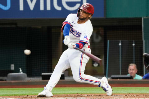 Oct 2, 2021; Arlington, Texas, USA; Texas Rangers left fielder Willie Calhoun (5) hits a home run against the Cleveland Indians during the first inning at Globe Life Field. Mandatory Credit: Jim Cowsert-USA TODAY Sports