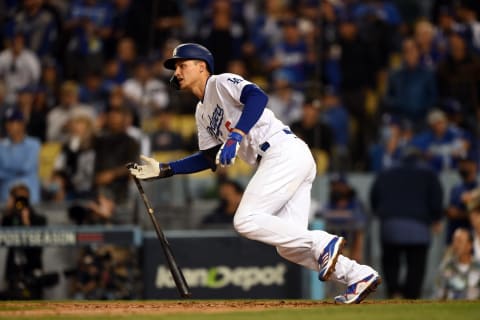 Oct 21, 2021; Los Angeles, California, USA; Los Angeles Dodgers shortstop Corey Seager (5) hits a single in the eighth inning against the Atlanta Braves during game five of the 2021 NLCS at Dodger Stadium. Mandatory Credit: Jayne Kamin-Oncea-USA TODAY Sports