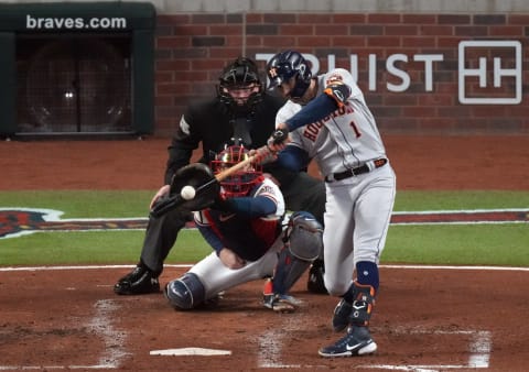 Oct 31, 2021; Atlanta, Georgia, USA; Houston Astros shortstop Carlos Correa (1) hits an RBI double against the Atlanta Braves during the third inning of game five of the 2021 World Series at Truist Park. Mandatory Credit: John David Mercer-USA TODAY Sports